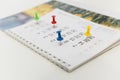 Colorful pins push marking on a calendar. Busy schedule Royalty Free Stock Photo