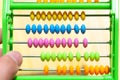 Colorful plastic abacus toy with multi colored beads, closeup. Kids and math, primary school simple mathematics teaching aids Royalty Free Stock Photo