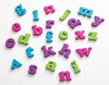 Colorful plastic alphabet letters on a white background