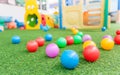 Colorful plastic ball on green turf at school playground Royalty Free Stock Photo