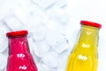 colorful plastic bottles with ice cubes white desk background top view mockup Royalty Free Stock Photo