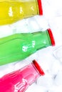 colorful plastic bottles with ice cubes white desk background top view mockup Royalty Free Stock Photo