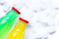 Colorful plastic bottles with ice cubes white desk background top view mockup Royalty Free Stock Photo