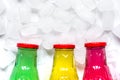 Colorful plastic bottles with ice cubes white desk background top view mockup Royalty Free Stock Photo