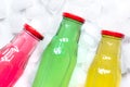 Colorful plastic bottles with ice cubes white desk background top view mockup Royalty Free Stock Photo