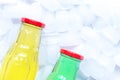 colorful plastic bottles with ice cubes white desk background top view mockup Royalty Free Stock Photo