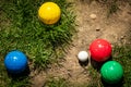 Colorful plastic boules or boccia balls are lying on a green meadow Royalty Free Stock Photo
