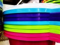 Colorful plastic bowls displayed on shelves for sale in a supermarket Royalty Free Stock Photo