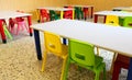 colorful plastic chairs and small tables in the nursery