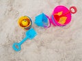 Colorful plastic children`s beach toys on sand beach in summer day. Kids toys, bucket, shovel Royalty Free Stock Photo