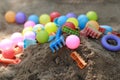 Colorful plastic children toys in sand pit Royalty Free Stock Photo