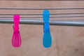 Colorful plastic clothes pegs on empty metal clothes dryer