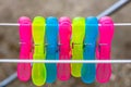 Colorful plastic clothes pegs on the empty metal clothes dryer Royalty Free Stock Photo