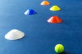 Colorful plastic cones on a blue cement tennis court Royalty Free Stock Photo