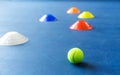 Colorful plastic cones on a blue cement tennis court Royalty Free Stock Photo