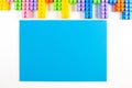 Colorful plastic construction blocks frame and blue blank card on white background Royalty Free Stock Photo