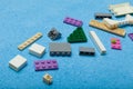 Colorful plastic constructor, toy details on a blue background. Parts of bright small parts for construction Royalty Free Stock Photo