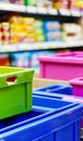 Colorful plastic crates stacked in front of grocery shelves with packaged goods Royalty Free Stock Photo