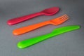 Colorful Plastic Cutlery set on gray. Royalty Free Stock Photo