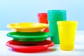 Colorful plastic dishes on white table Royalty Free Stock Photo