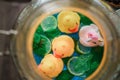 Colorful plastic ducks in a glass jar of lemonad on a wooden background Royalty Free Stock Photo