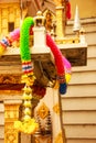 Colorful plastic flower garland on Traditional Thai outdoor spirit house shrine