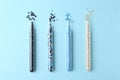 Colorful plastic granules in test tubes on light blue background, flat lay Royalty Free Stock Photo