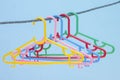 Colorful plastic hangers on the rope on wall blur background. Royalty Free Stock Photo