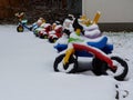 Colorful plastic kids toys in playground with snow cover Royalty Free Stock Photo