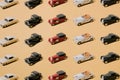 Colorful plastic and metal old automobiles toys. Classic cars beige, red, black and white colors. Old timer on yellow gold luxury Royalty Free Stock Photo