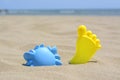 Colorful plastic molds on sand near sea, space for text. Beach toys Royalty Free Stock Photo