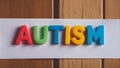 Colorful Plastic Neon Letters spelling Autism in Bold Typography - AI Generated Royalty Free Stock Photo