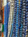 Colorful plastic rosaries close up shot in the market. Beautiful Muslim prayer beads close up view. Colorful chaplets for prayers