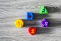 Colorful plastic shapes with numbers on a wooden background