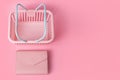 Colorful plastic shopping baskets with leather wallet. Empty pink and blue supermarket basket on pink pastel background. Creative