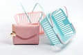 Colorful plastic shopping baskets with leather wallet. Empty pink and blue supermarket baskets on light grey background. Creative