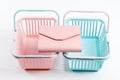 Colorful plastic shopping baskets with leather wallet. Empty pink and blue supermarket baskets on light background. Creative