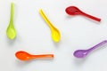 Colorful plastic spoon on white table background with c Royalty Free Stock Photo