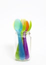 Colorful plastic spoons and forks in jar . Royalty Free Stock Photo