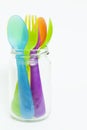 Colorful plastic spoons and forks in jar . Royalty Free Stock Photo