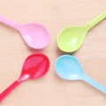 Colorful plastic spoons on wood Royalty Free Stock Photo