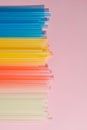 Colorful plastic straws on light background. Event and party supplies. Earth pollution concept