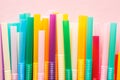 Colorful plastic straws on pastel pink Royalty Free Stock Photo