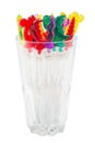 Colorful plastic swizzle sticks in glass on white background wit Royalty Free Stock Photo