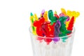 Colorful plastic swizzle sticks in glass on white background wit Royalty Free Stock Photo