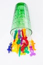 Colorful plastic swizzle sticks spilled from glass on white back Royalty Free Stock Photo