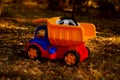 Colorful plastic toy dumpster truck outdoors Royalty Free Stock Photo