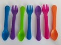 Colorful plastic utensils on a white background Royalty Free Stock Photo