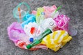 Colorful plastic waste, bags, cups, bottles, straws on cement floor Royalty Free Stock Photo