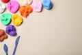 Colorful plasticine and tools on beige, flat lay. Space for text Royalty Free Stock Photo